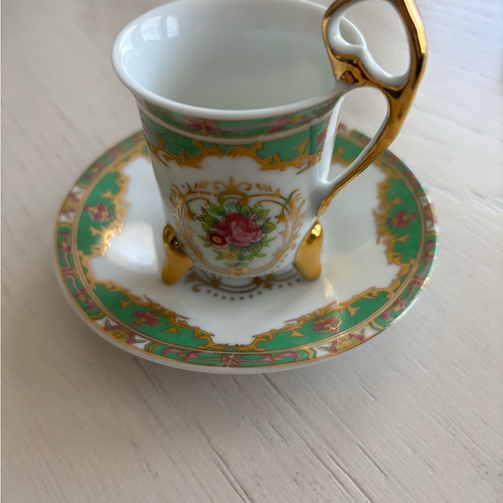 Elegant Porcelain Cup and Saucer with Gold and Green Accents